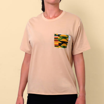 Woman wearing tan t-shirt with African Wax fabric chest pocket