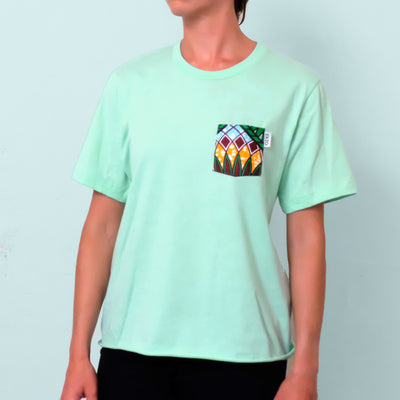 Woman wearing mint t-shirt with floral patterned chest pocket